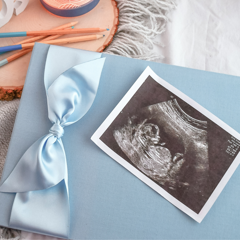 blue cloth baby memory book with blue satin ribbon baby registry must haves