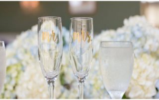 clear Mr and Mrs Champagne glasses against a flower backdrop