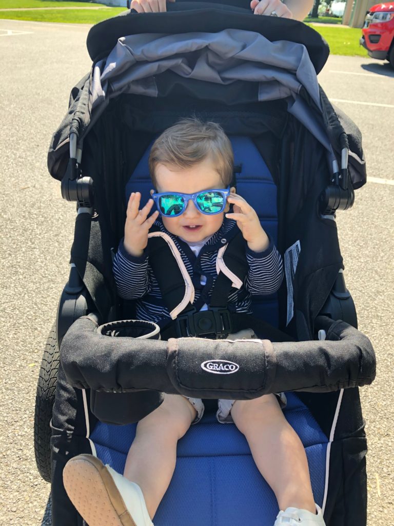 Baby in stroller with sun glasses outside 