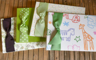 Baby Memory Books with ribbons on wooden background