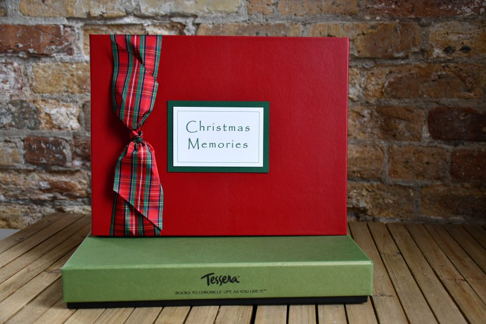 Christmas Memory Book with plaid ribbon bow and plaque on top of tessera green gift box