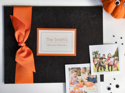 Black paper halloween memory book with orange grosgrain bow and plaque
