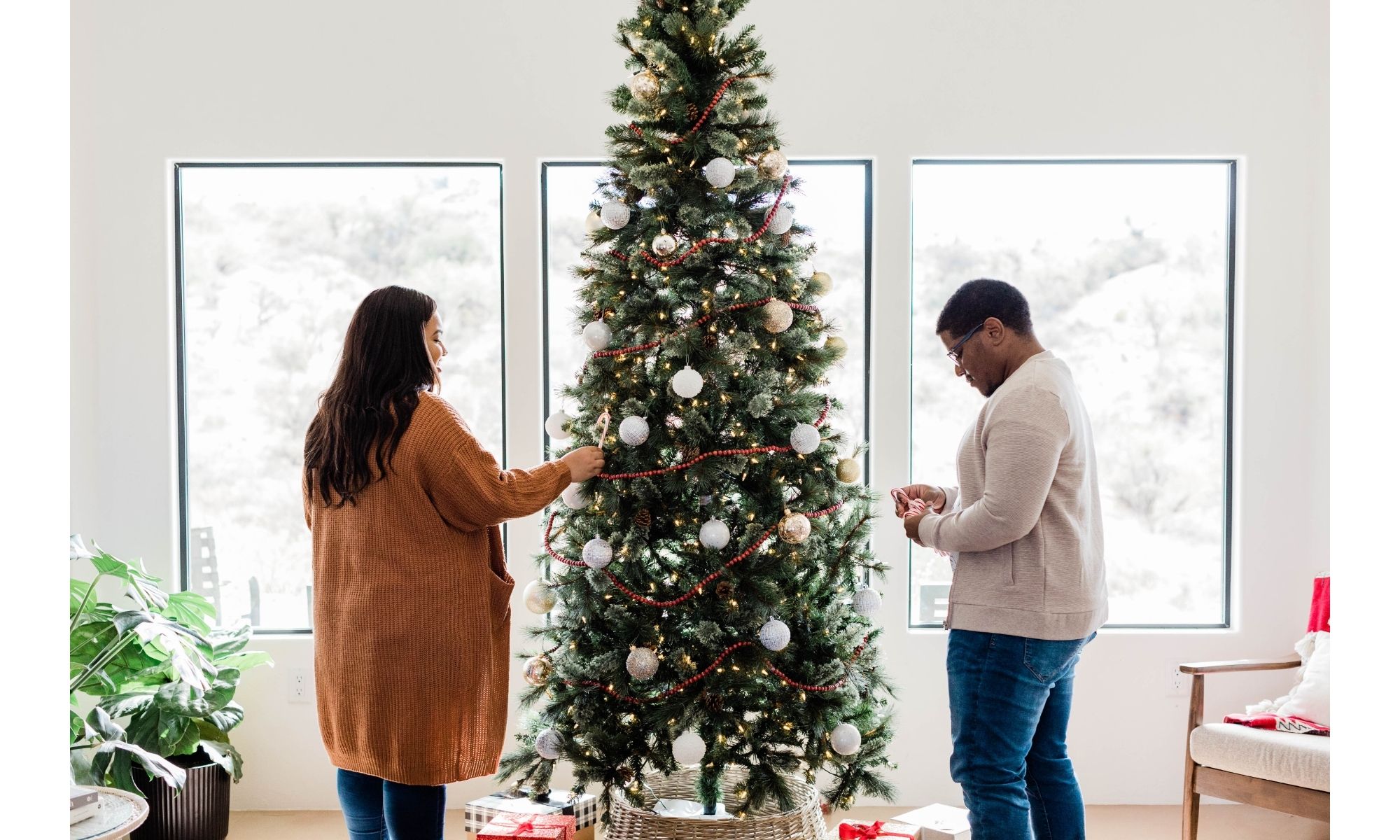 Man and woman decorating the Christmas tree