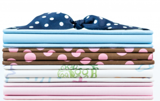 Stack of memory books with blue polka dot grosgrain ribbon on top