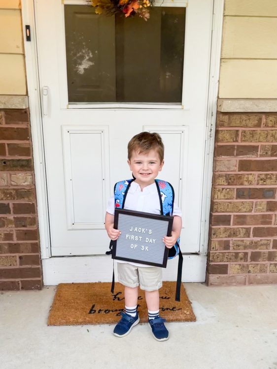 toddler holding first day of 3k sign on first day of school