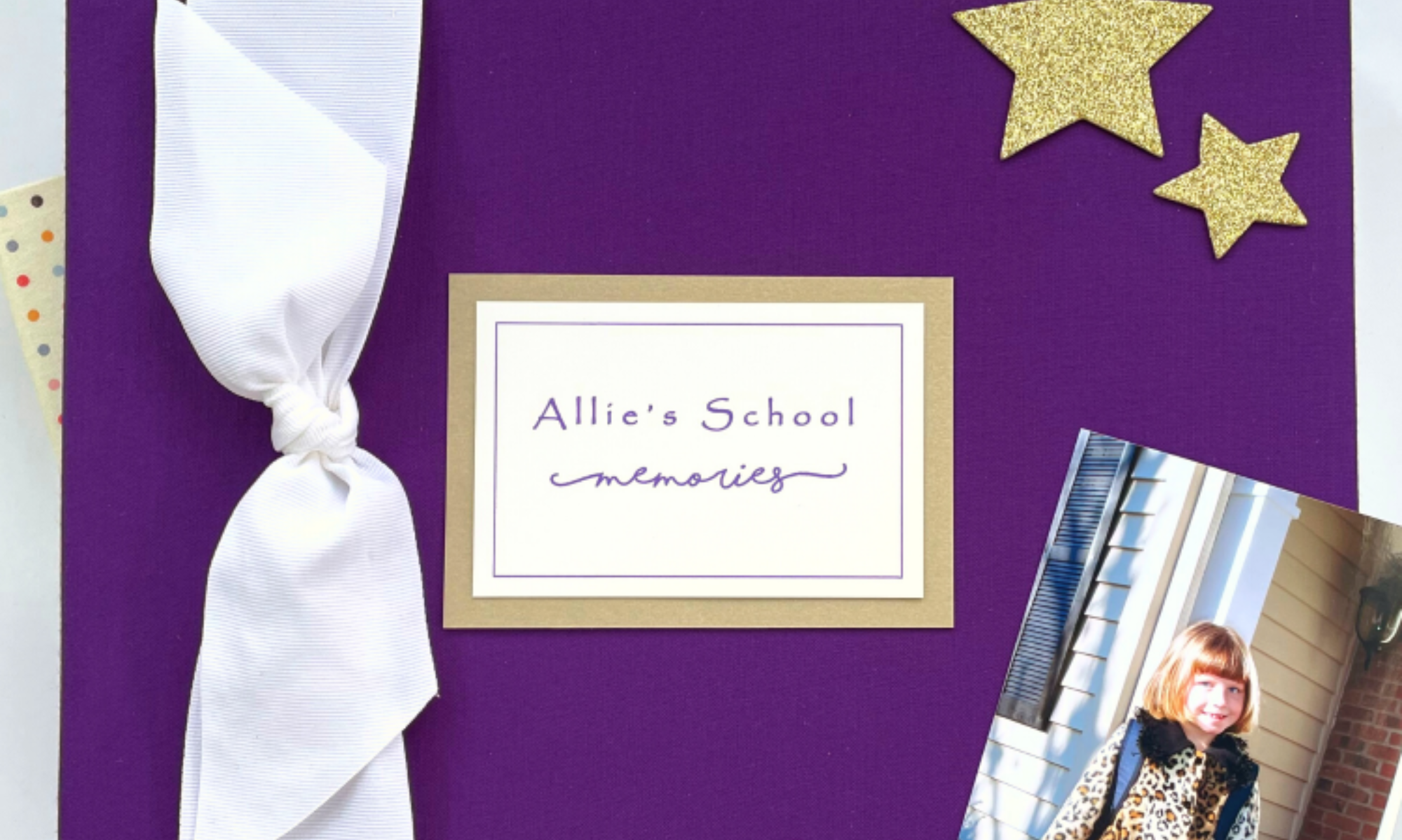 Purple cloth cover grade school memory book with white grosgrain bow and gold name plaque