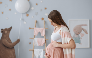 pregnant woman standing in nursery