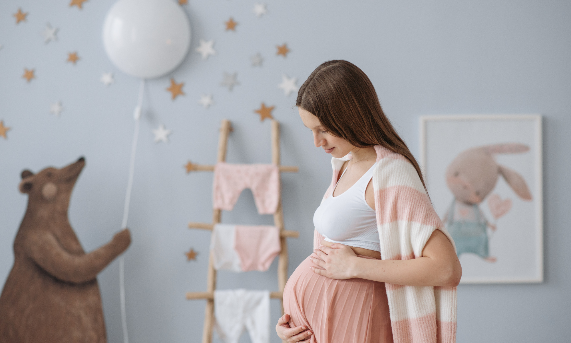 pregnant woman standing in nursery