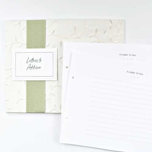 Letters to You Keepsake shown with white leaf silk cover, celery grosgrain layflat ribbon and personalized plaque