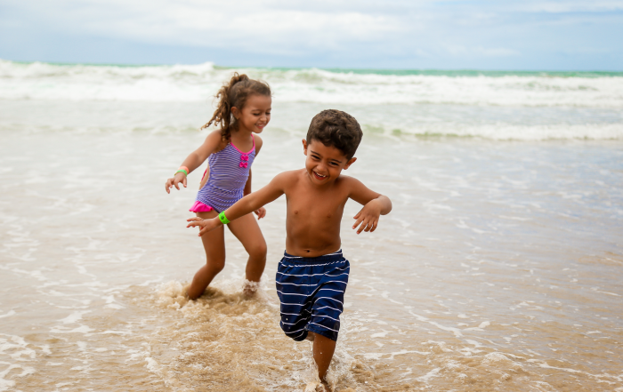 capturing your kid's summer activities photo of two kids running on the beach